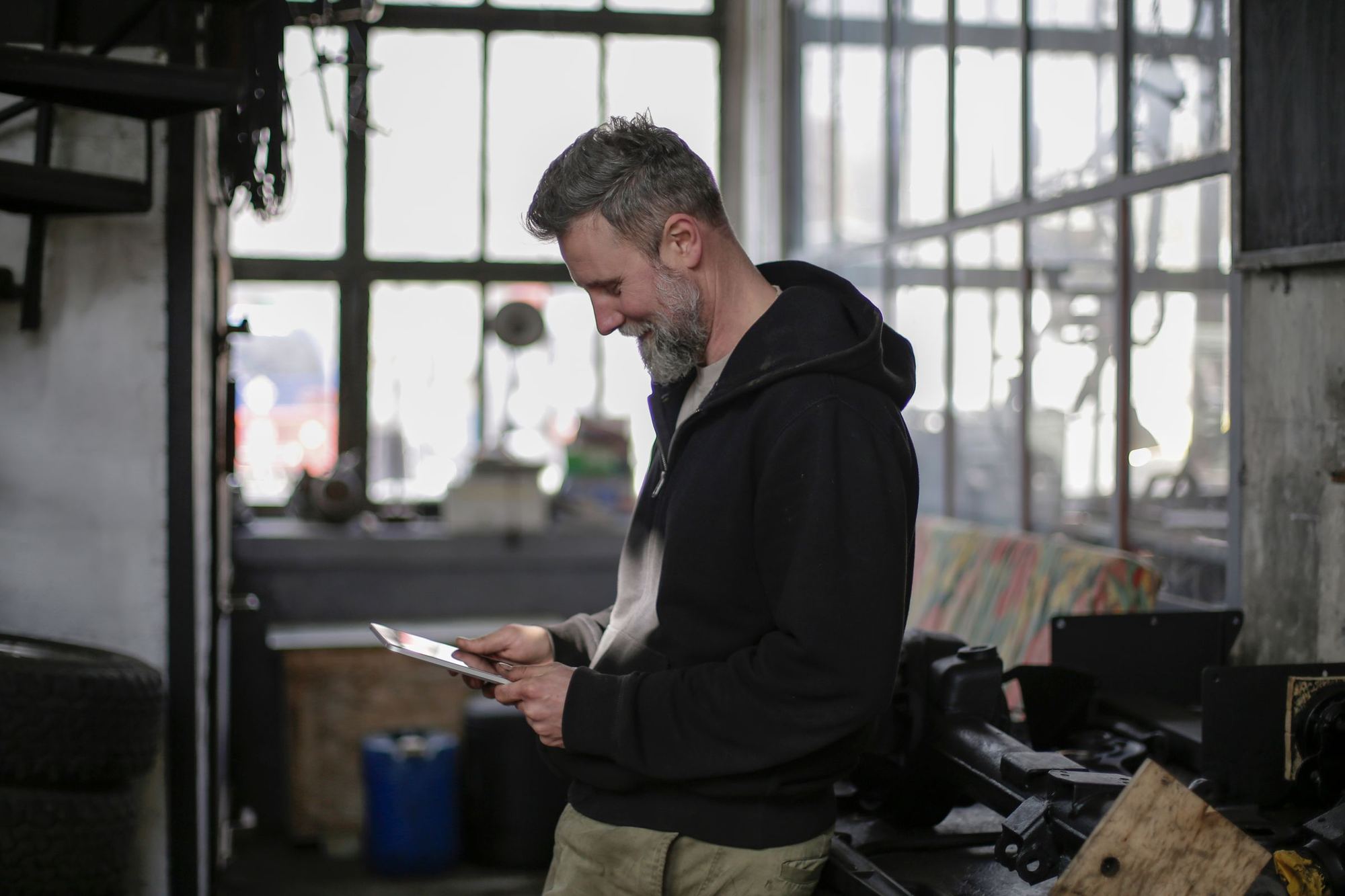 A worker checking a tablet in a workshop.